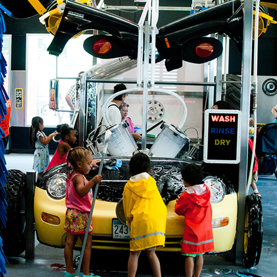 kids playing with a car wash exhibit