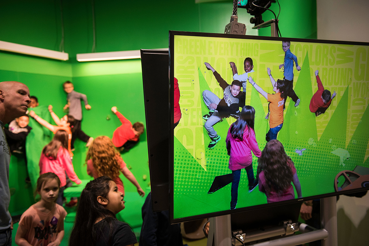 children playing with a green screen