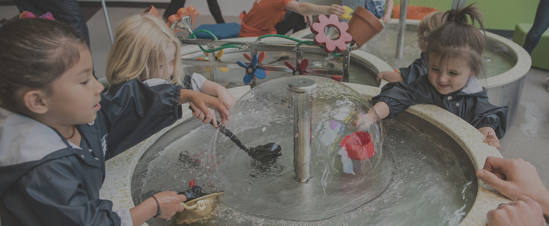 children playing with a water table